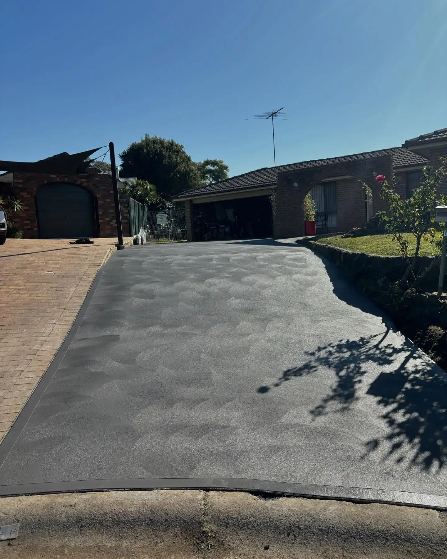Charcoal driveway that replaced old brick pavers