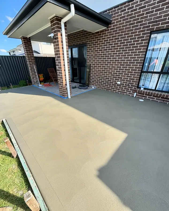 New alfresco slab outside a brick house