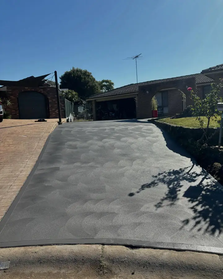 Charcoal driveway that replaced old brick pavers