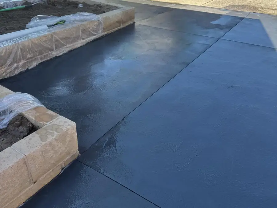Charcoal driveway sandstone wall