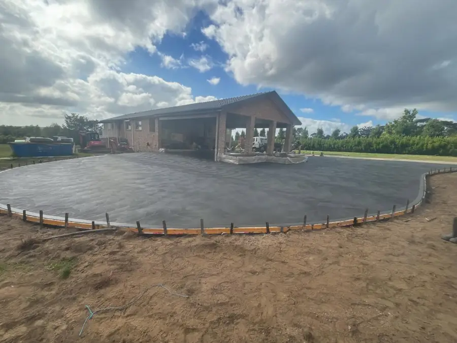 Circular driveway in front of a carport on acreage