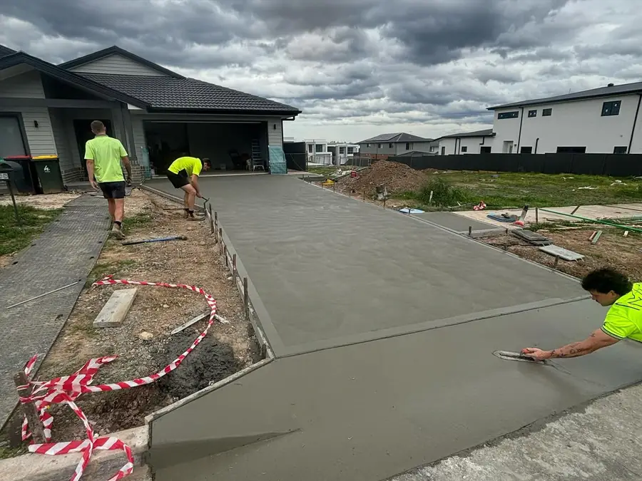 Crew edging a fresh driveway pour