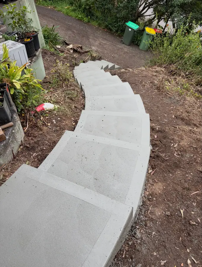 Curved concrete garden steps climbing a bush slope