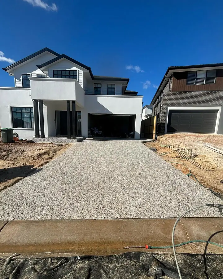 Exposed aggregate driveway in front of a new two-storey house