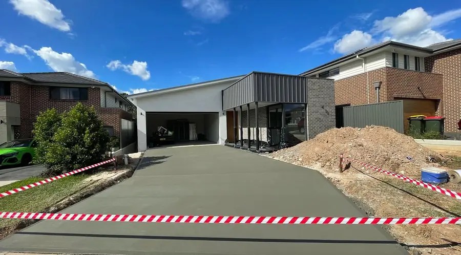 Wide plain driveway in front of a new house